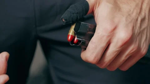 Reloading a weapon close-up macro. Adding cartridges to the firearms magazine Stock-Footage 273509430