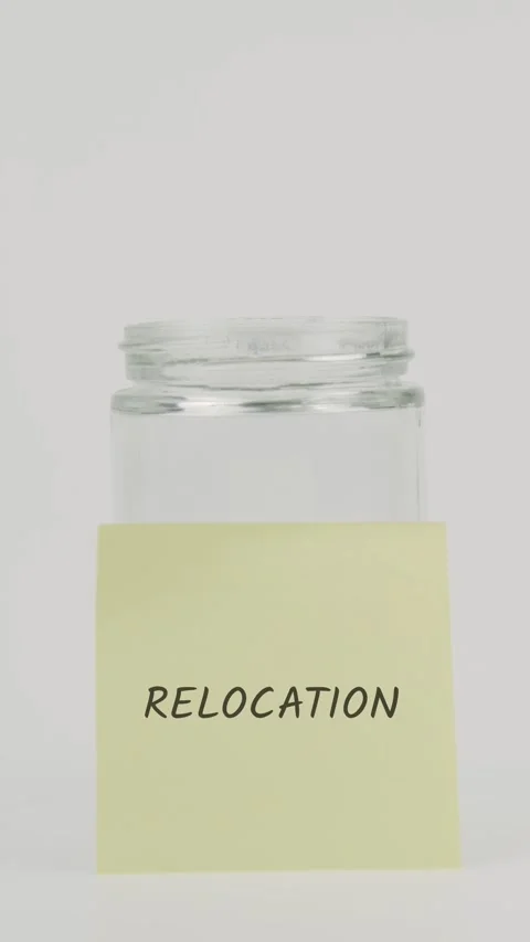 Relocation text or word on yellow sticky note attached to glass jar Stock Footage 311777048