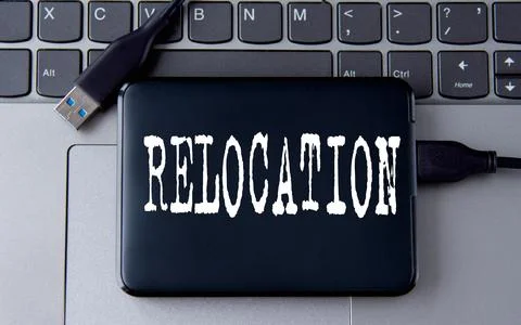 RELOCATION- word on an external drive in gray letters on the background of .. Stock Photos