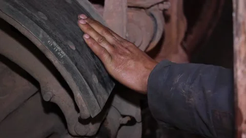 Rem 030An auto mechanic does his job, repairs a huge quarry dump truck. Stock Footage 124576592