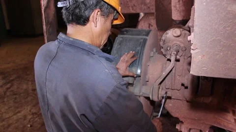 Rem 031An auto mechanic does his job, repairs a huge quarry dump truck. Stock Footage 124576598