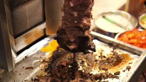 Remaining Shawarma Meat Rotating on Vertical Spit at Street Food Stall Stock Footage 322007178
