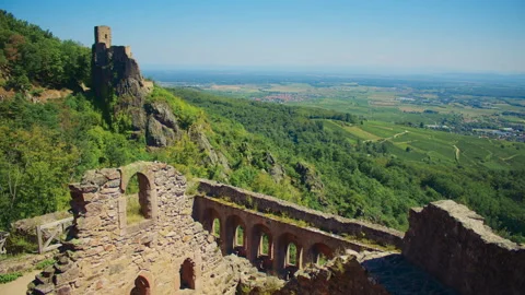 Remains of ancient castle wall stretch across hillside revealing medieval castle Stock-Footage 327569096