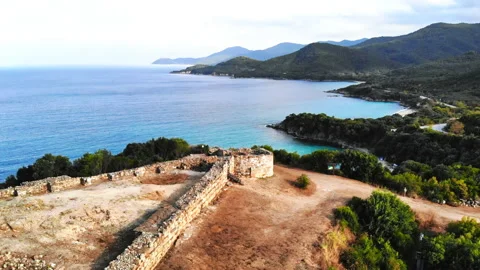 Remains of ancient structures on the top on the hill. Hills covered with lush Stock Footage 145167514