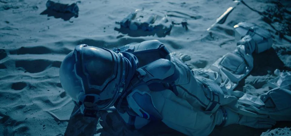 Remains of a dead astronaut lying on a planet Stock Photos