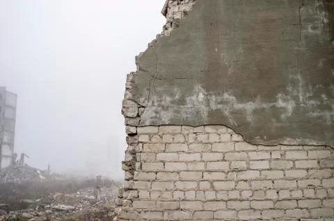 The remains of the destroyed wall of the building silicate white brick with Stock Photos