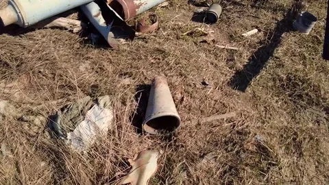 Remains of exploded ammunition, shells of multiple launch rocket systems Stock Footage 313365141
