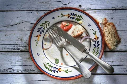 The remains of food and bread on an empty plate Stock Photos