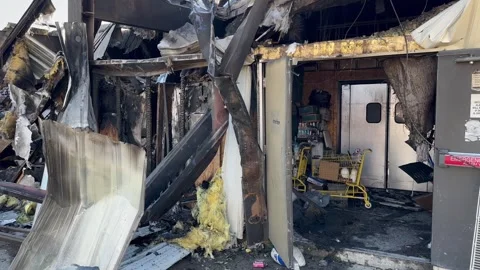 The remains of a large fire at a Dollar General Store Stock Footage 333780822