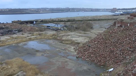 Remains of old ship yard, long out of use, with piles of red brick Stock Footage 1090473
