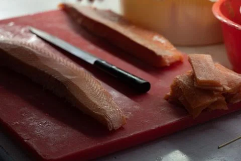 Remains of red fish after processing for sushi in a professional kitchen. Stock Photos