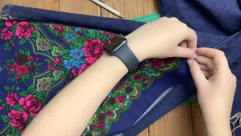 Remaking clothes on wooden background. Video stock 156000183