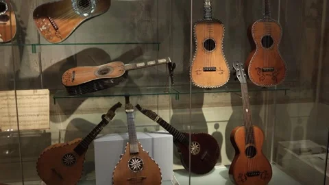 A remarkable collection of antique guitars and mandolins displayed in a museum,  Stock Footage 293565539