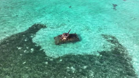A remarkable drone shot capturing a submerged WWII Sherman tank in the clear 스톡 동영상 327766984