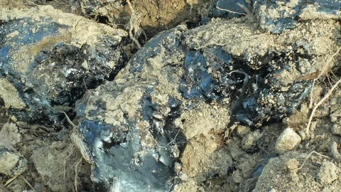 Remediation of contamination pollution, toxic tar asphalt chemical in detail Stock Footage 111908925