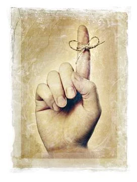 Remember Stained, grainy and gritty image of a hand with a string tied aro... Stock Photos