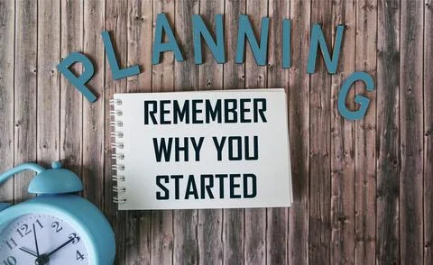 Remember why you started, text like planning on notepad and wooden table with Stock Photos