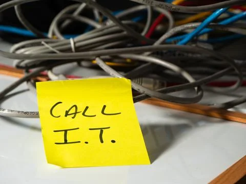 Reminder note to call network technician with messy cables background Stock Photos