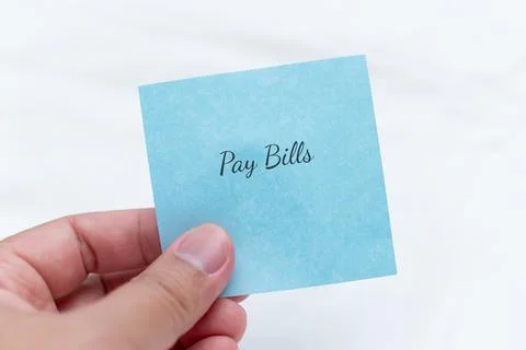 Reminder note to pay bills by hand home office visual reminder calm environment Stock Photos