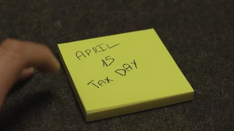 Reminder Note for Tax Day on Office Desk Stock Footage 333489684