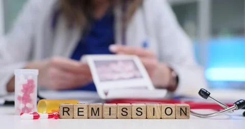 Remission word placed on table near pills and ultrasound photo Stock Footage 314123915