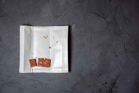 The remnants of chocolate lie on an open wrapper. Stock Photos