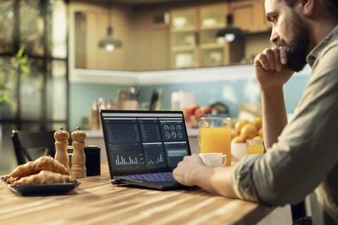 Remote administrator, laptop displaying analytics, charts and research data 스톡 사진