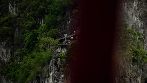 A Remote and Lush Mountain Outpost Nestled on a Steep Cliff, Surrounded by Dense Video stock 310169352