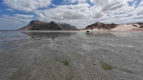 Remote beach with reflective water and mountains Stock Footage 340198258