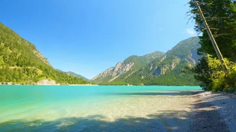 Remote Beach Spots and Mountain Backdrop at Plansee Lake in Tyrol  A Natural Stock Footage 308647626