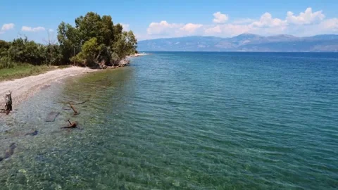 Remote beach surrounded by green hills and blue sea in Greece Stock Footage 319749285