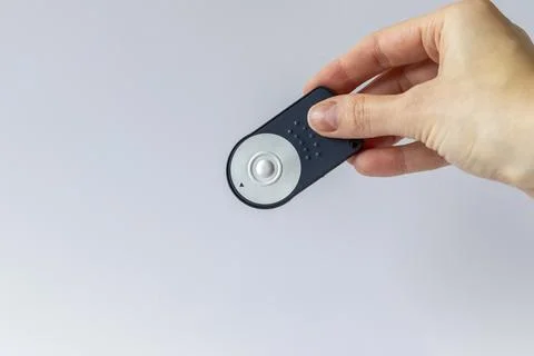 The remote button for the camera in a woman's hand. Copy space Stock Photos