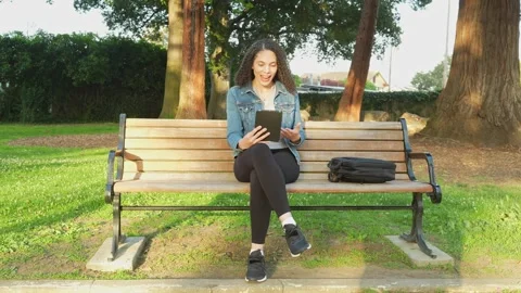 Remote Call on a Tablet in the Park on a Sunny Day. Stock Footage 310629604