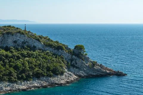 Remote cap with pine trees and signalling device in Adriatic sea Foto stock