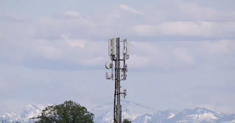 Remote Cell Station Amidst Mountains. Telecom Equipment On Mountaintop With Clou 库存影片 335579058
