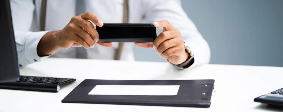 Remote Check Deposit Using Mobile Phone Stock Photos