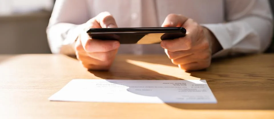 Remote Check Deposit Using Mobile Remote Stock Photos