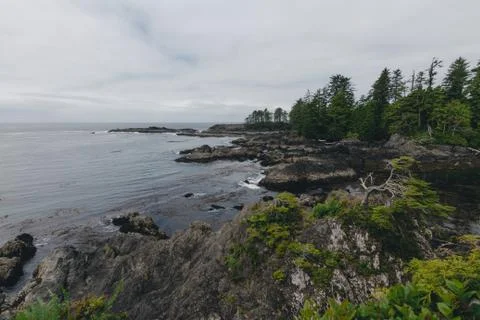 Remote coastal view with islands, cliffs and clouds Stock Photos