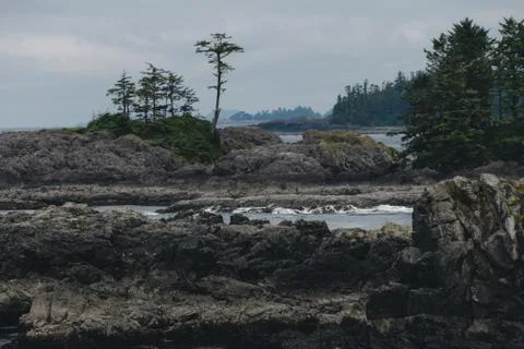 Remote coastal view with islands, cliffs and clouds Stock Photos