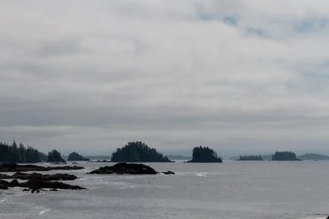 Remote coastal view with islands, cliffs and clouds Stock Photos