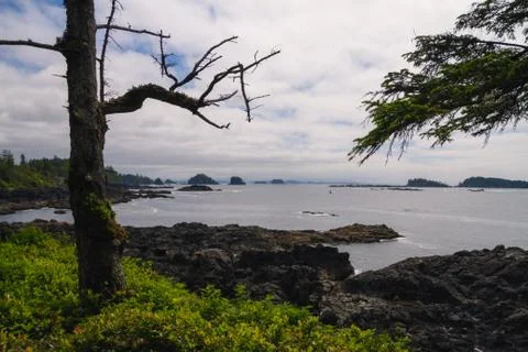 Remote coastal view with islands, cliffs and clouds Stock Photos