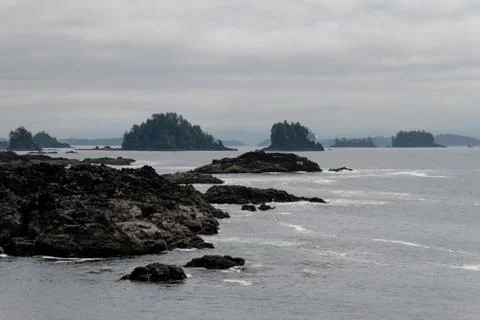 Remote coastal view with islands, cliffs and clouds Stock Photos