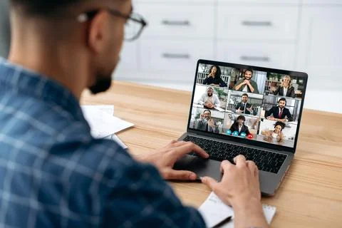 Remote communication. View over the shoulder of a guy, on a laptop screen with a Stock-Fotos