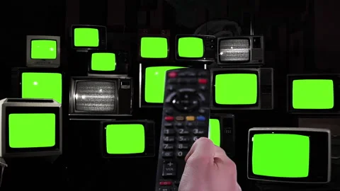 Remote Control Activating Multiple Old TVs With Green Light, Black and White Stock Footage 304009164