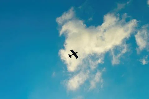A remote control aeromodelling airplane on a cloudy blue sky background. pe.. Stock Photos