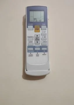 Remote control of air condition control hang on the wall. Stock Photos