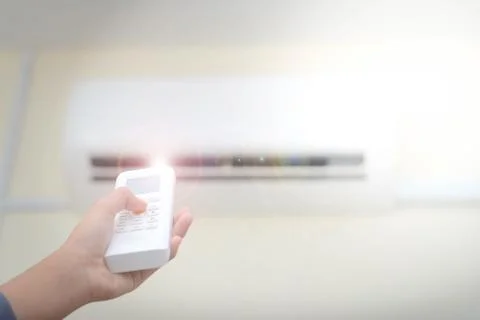 Remote control air conditioner concept Stock Photos