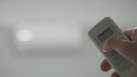 Remote control of the air conditioner when the room is hot Stock Footage 239132346