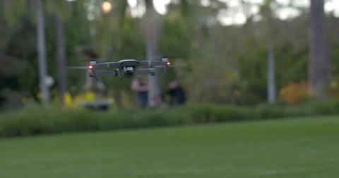 Remote control aircraft flying in park setting during day 4K Stock Footage 83673295