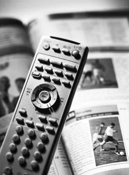 Remote control and tv program, close-up Stock-Fotos